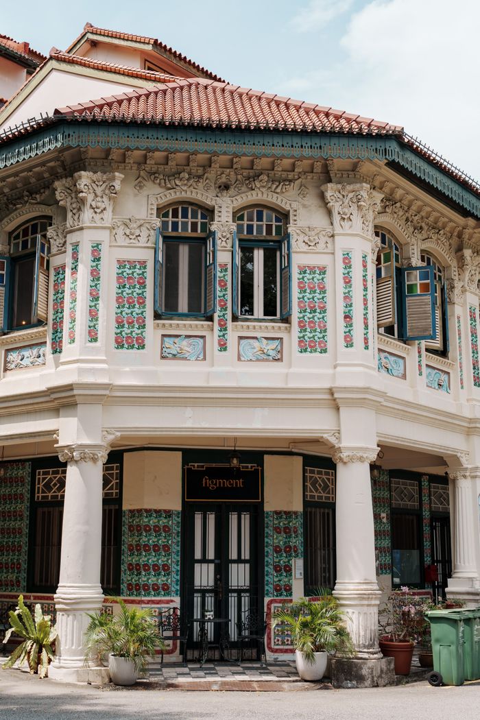 A beautifully preserved traditional Asian shophouse featuring colorful tiles and intricate architectural details.